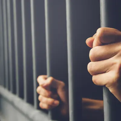 Jail bars and hands
