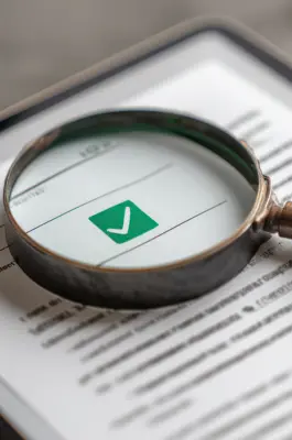 Magnifying glass reviewing a document on a tablet screen